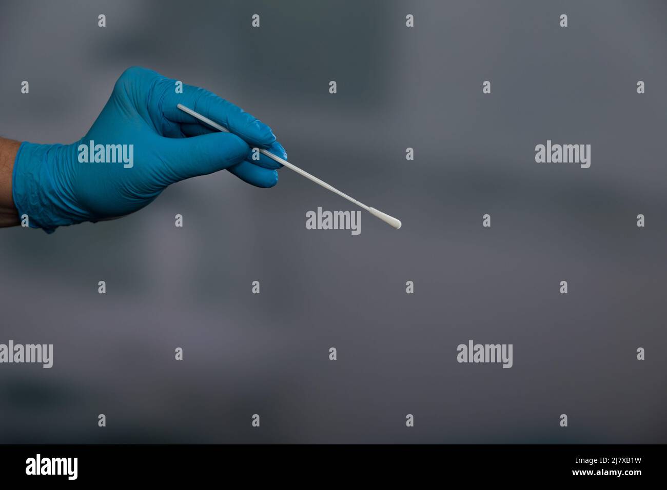Closeup of doctor's hand handling a smear test or swab test in a