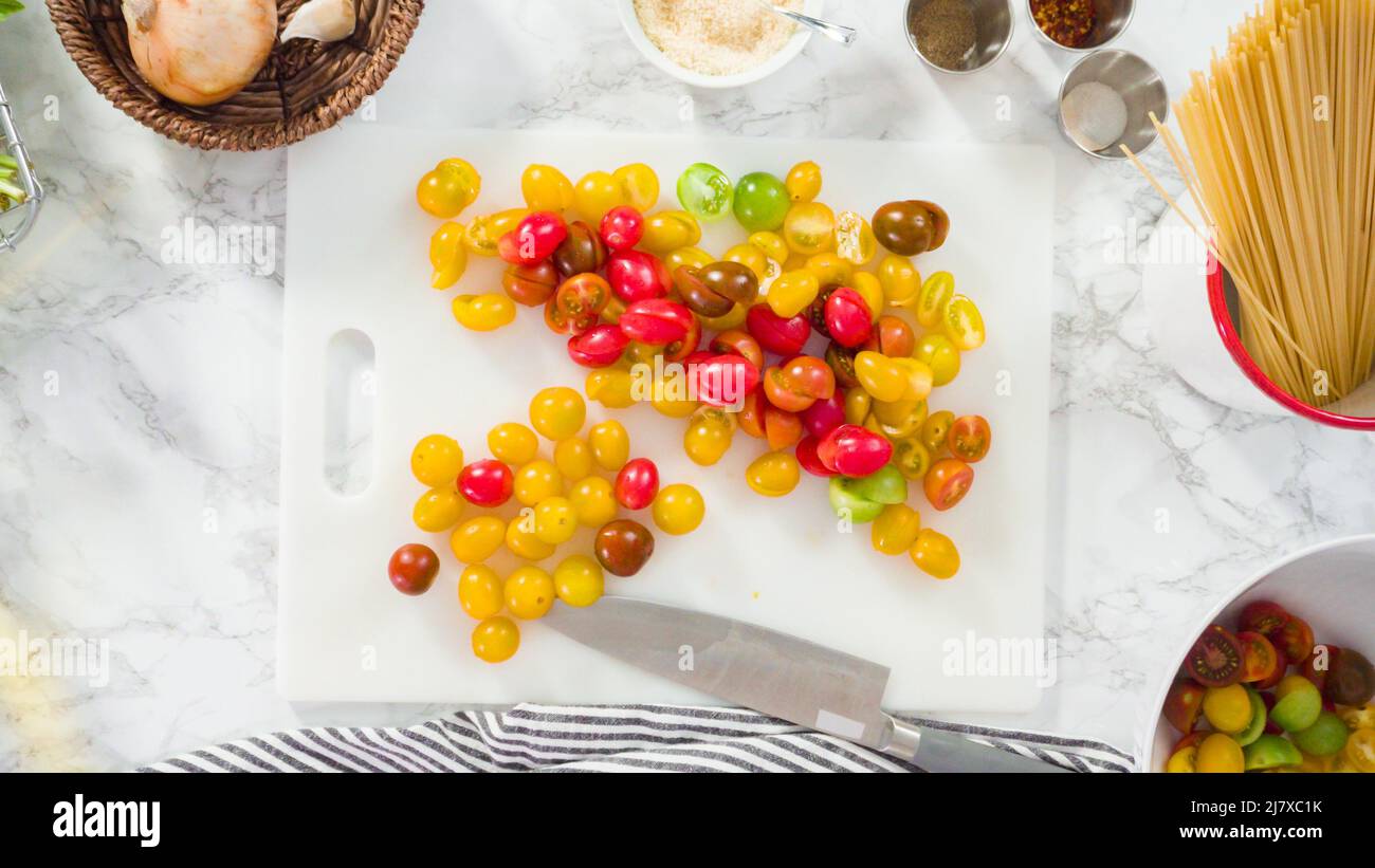 Flat lay. Step by step. Cutting vegetables on a white cutting board to