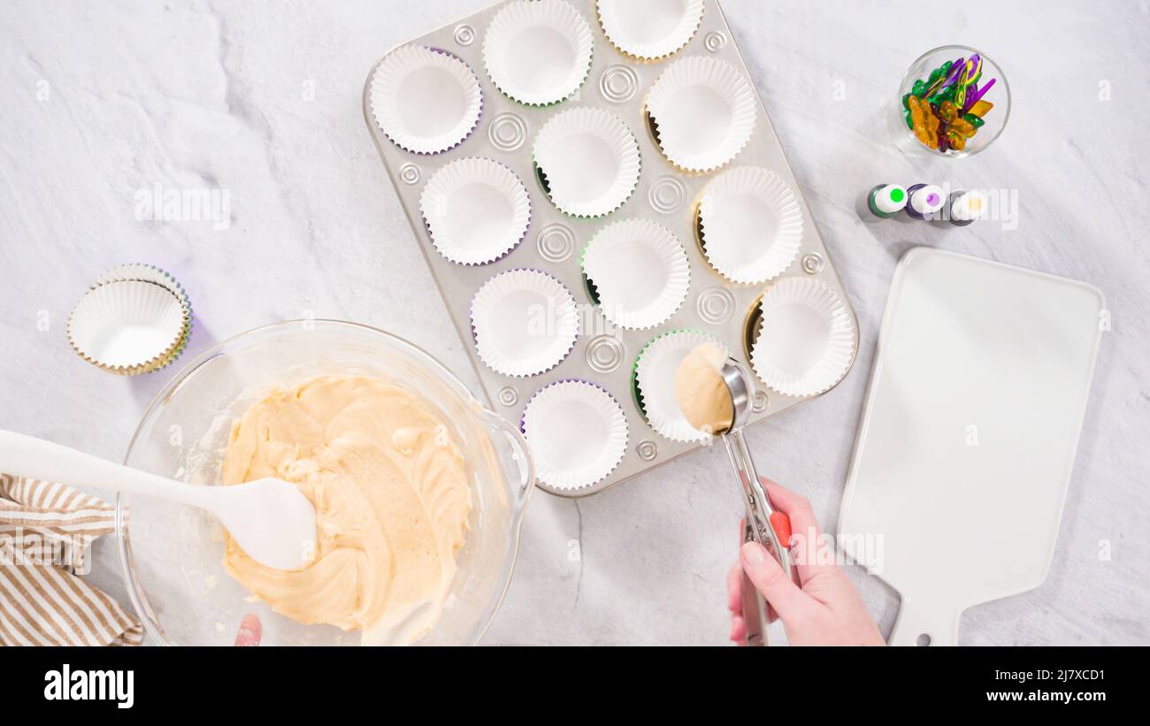 Step by step. Scooping batter with a cupcake scoop to make unicorn  chocolate cupcakes with buttercream frosting Stock Photo - Alamy