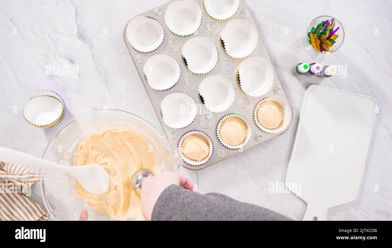 Flat lay. Step by step. Scooping cupcake batter into a foil cupcake