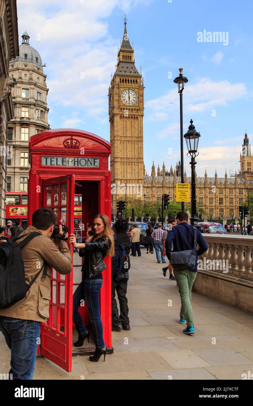 LONDON, GREAT  BRITAIN - MAY 15, 2014:  An unknown young couple takes a photoshoot near the most recognizable symbols of the city - Big Ben and the re Stock Photo