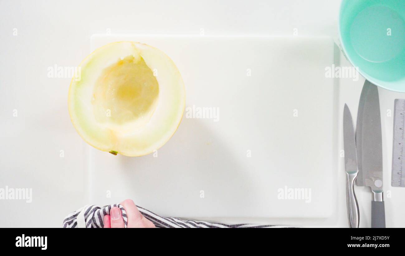Step by step. Flat lay. Slicong golden dewlicious melon on a white