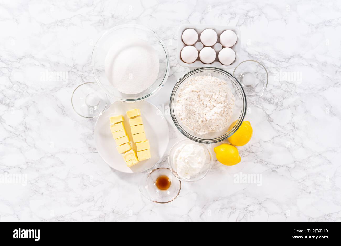 Flat lay. Ingredients in glass mixing bowls to prepare lemon bundt cake