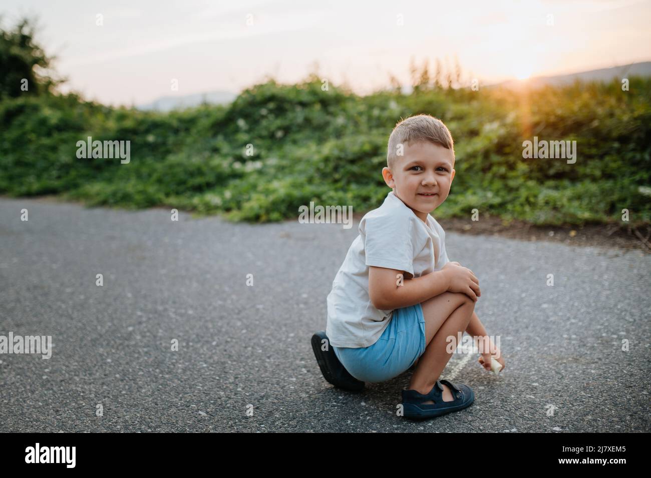 Little kid boy drawing with chalk on asphalt in summer Stock Photo - Alamy