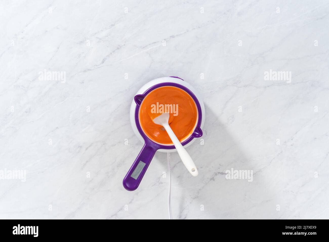 Flat lay. Melting chocolate chips in a candy melting pot to make a