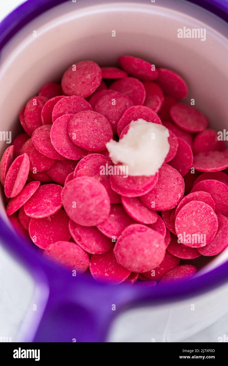 Melting chocolate chips in a candy melting pot to make a chocolate