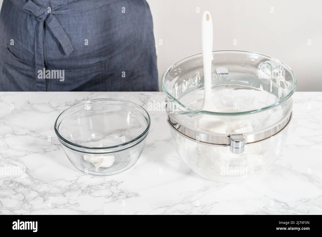 Mixing yellow food coloring into the meringue to bake Easter meringue