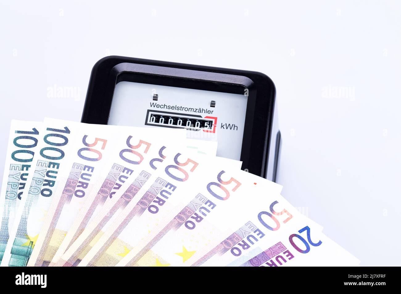 The photo shows an AC electricity counter with euro bills Stock Photo