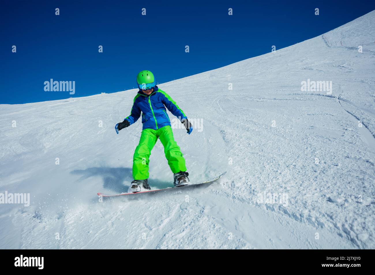 Action photo of boy snowboard down mountain slope fast Stock Photo Alamy