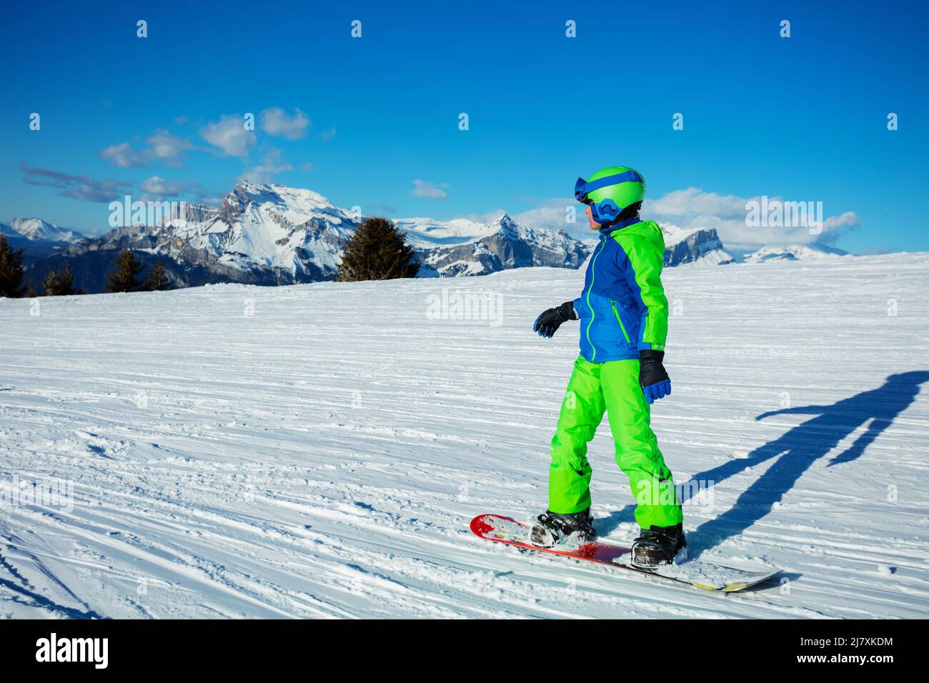 Snowboarder boy go downhill on snowboard from mountain top Stock Photo ...