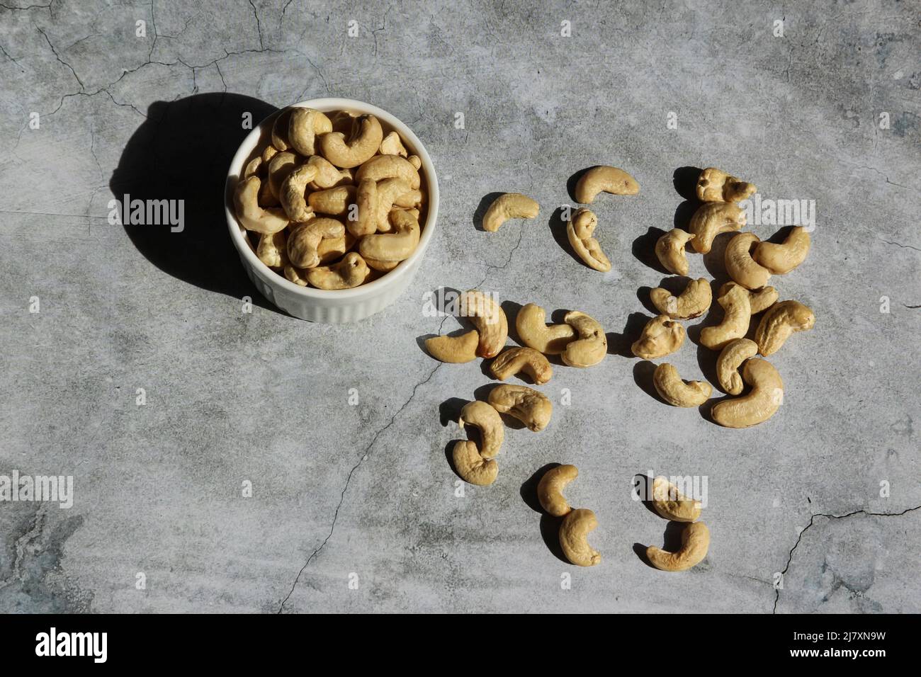Cashew nuts on the cement background. Top view. Stock Photo