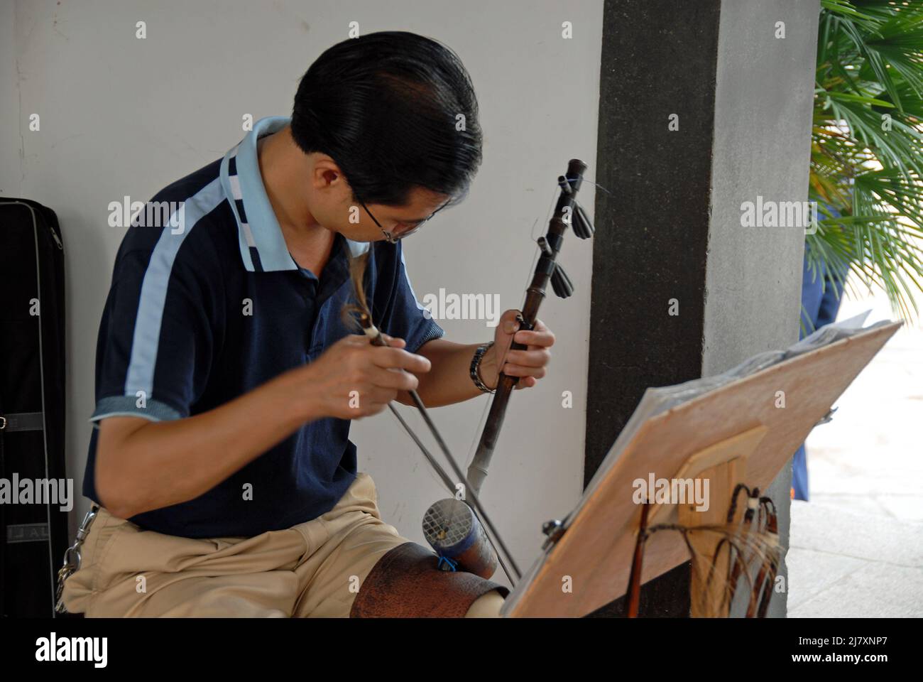 Changsha, Hunan Province, China Man playing an Erhu at Tianxin Pavilion. The erhu is a