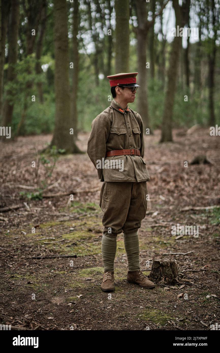 A Japanese soldier eats in the woods at the No Man's Land Event at Bodrhyddan Hall, Wales Stock Photo