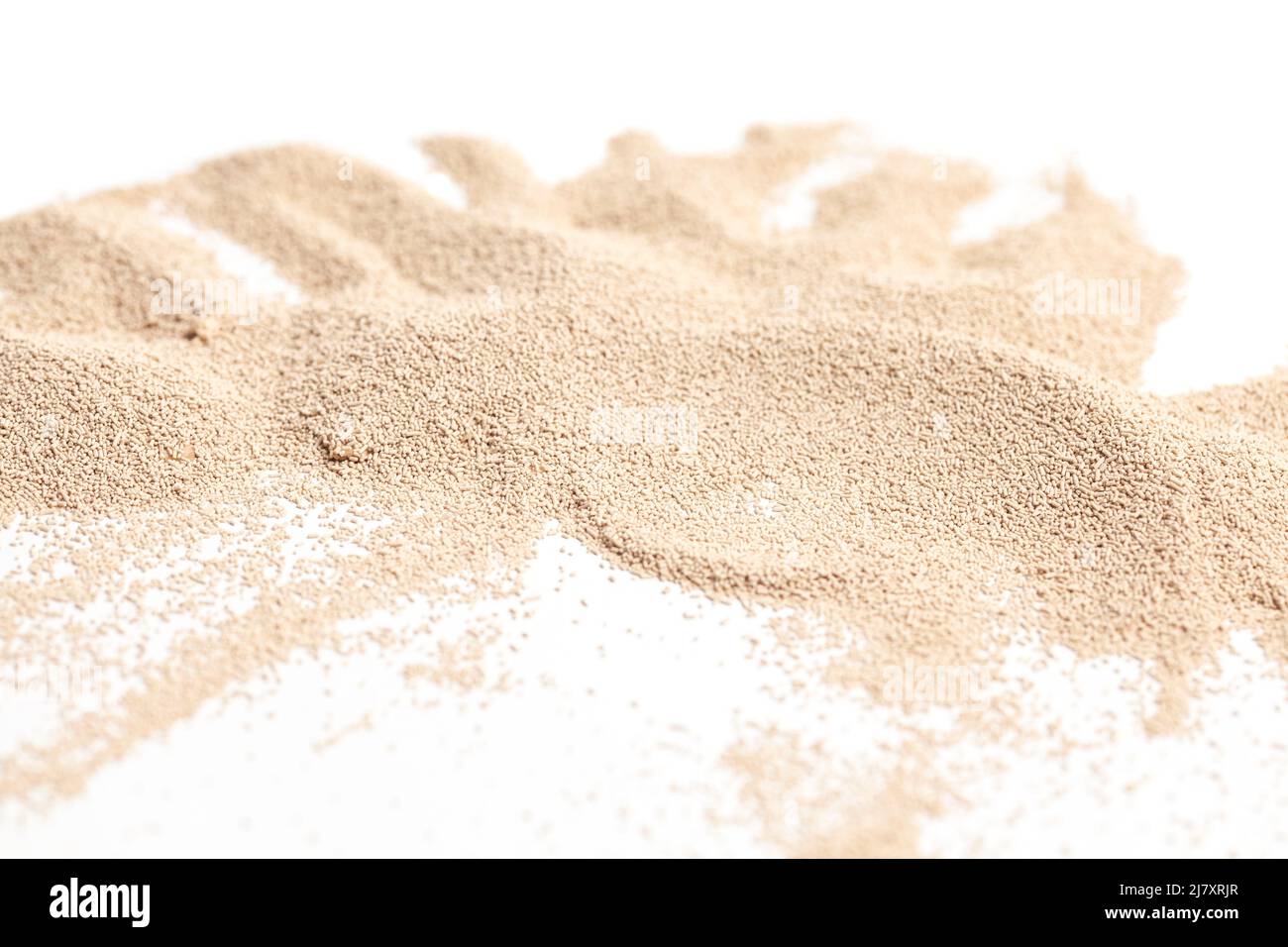 Active dry baking yeast granules isolated on white background Stock