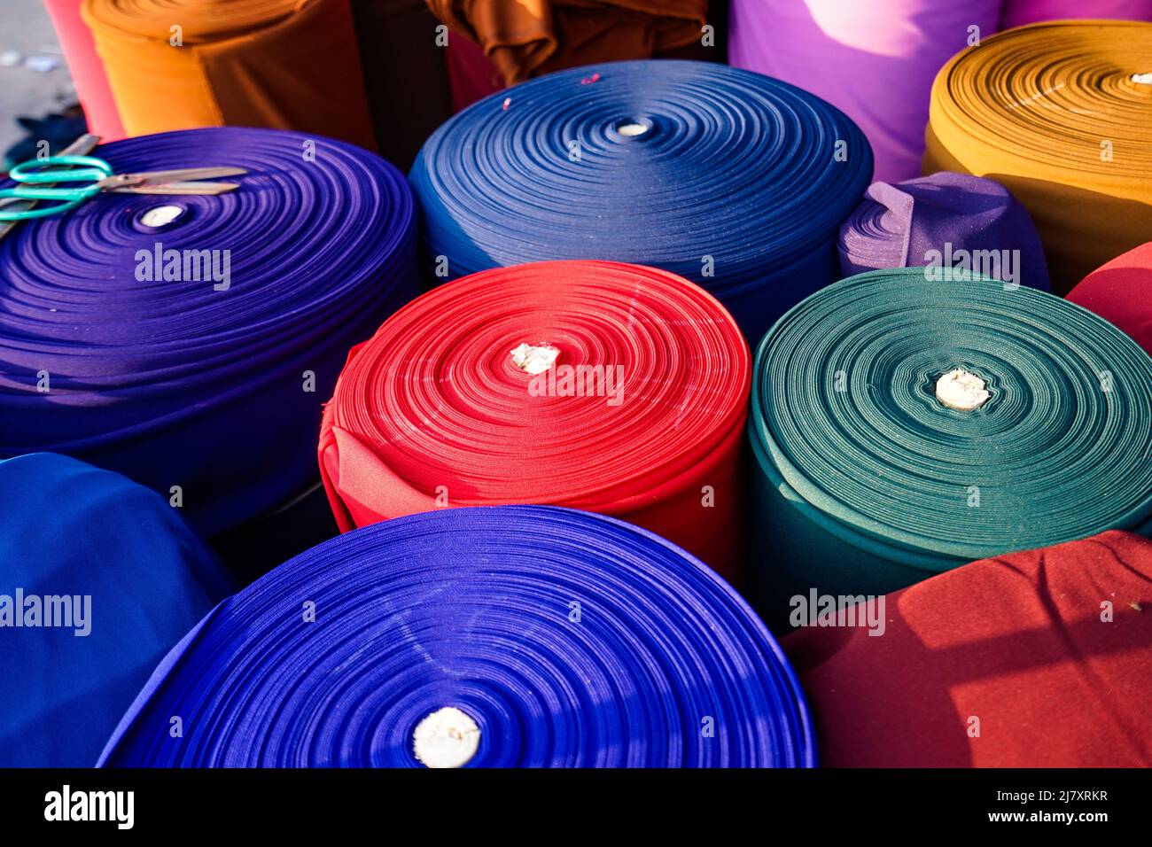 Colorful fabric rolls at a Vietnamese fabric market Stock Photo