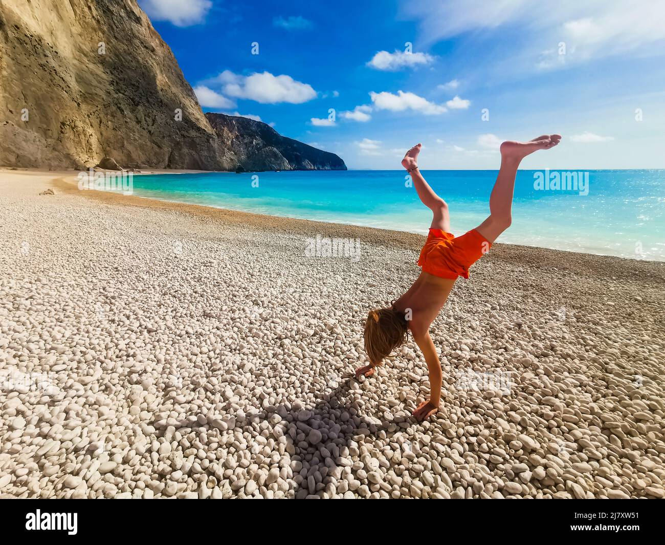 A young boy on an empty beach, Porto Katsiki, Greece Stock Photo