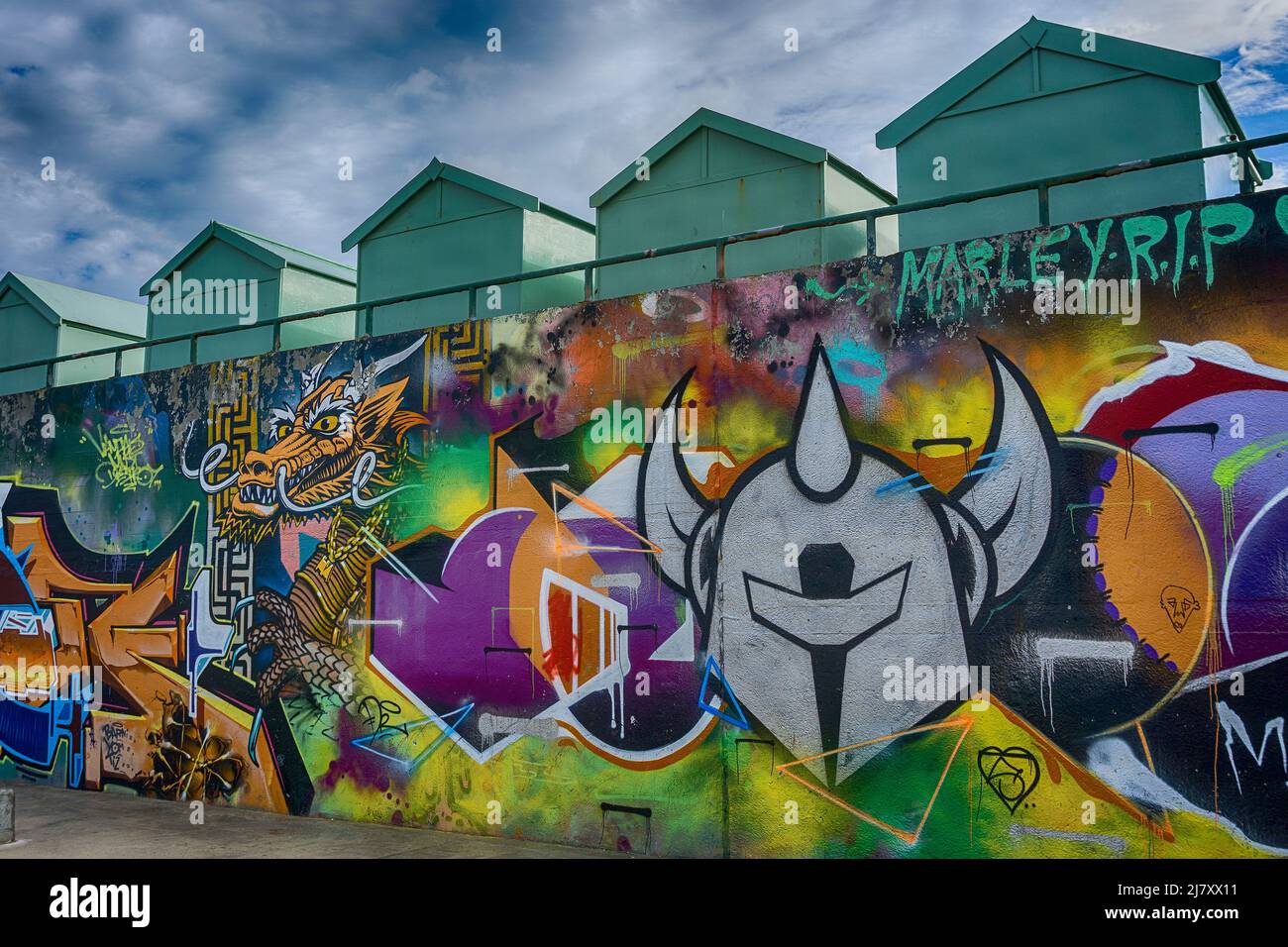 Colourful photo of Hove Lagoon Street art underneath the beach huts on Hove seafront Stock Photo
