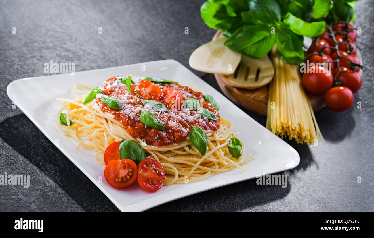 Composition with a plate of spaghetti bolognese Stock Photo - Alamy