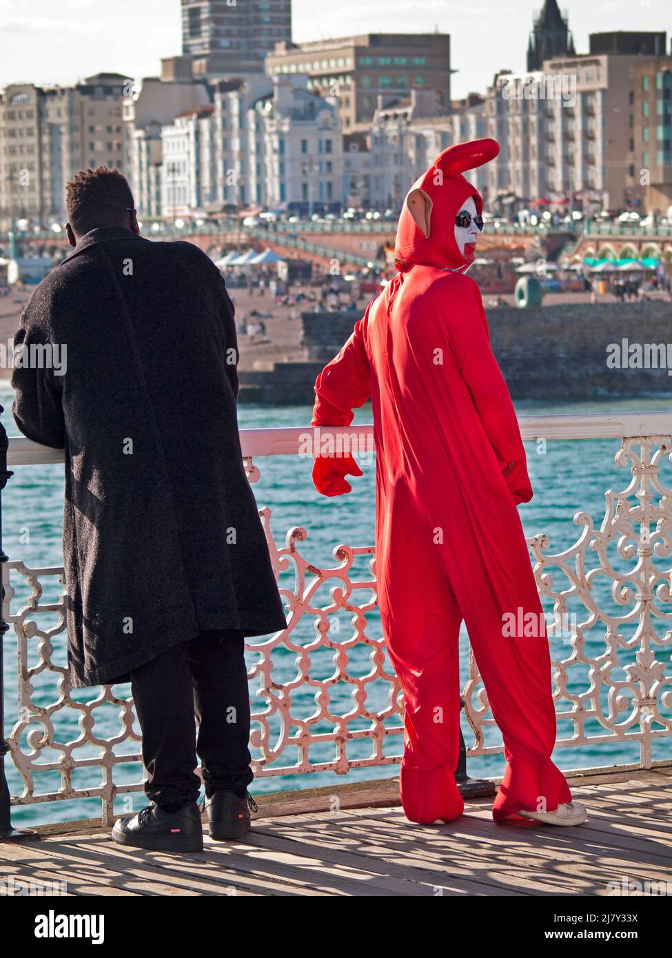 A man in a Teletubbies outfit on the pier at Brighton Stock Photo