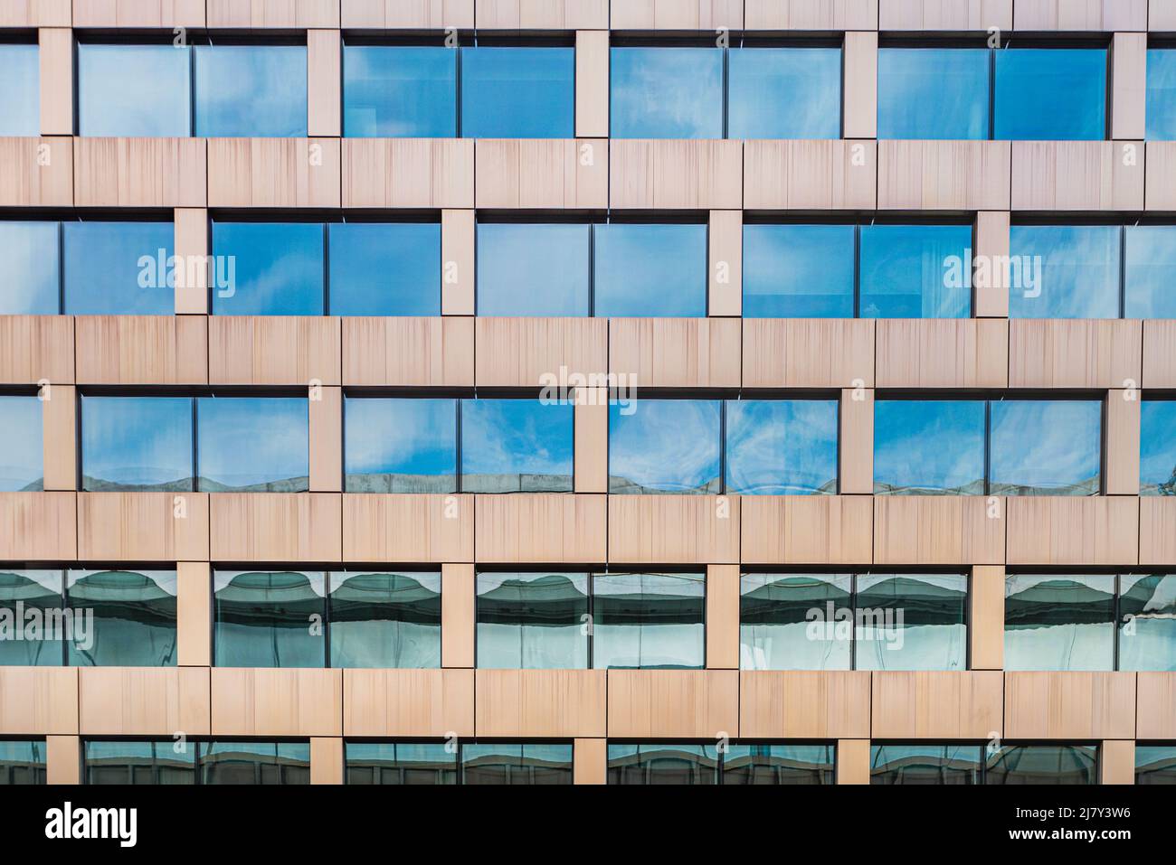 Modern or contemporary facade of a workplace with window pattern. Contemporary office facade with rectangular windows on modern multinational building Stock Photo