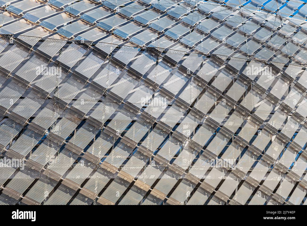 Pattern of metallic diamonds on modern building facade looks like a prison. Contemporary exterior shows a jail - like structure in modern architecture Stock Photo