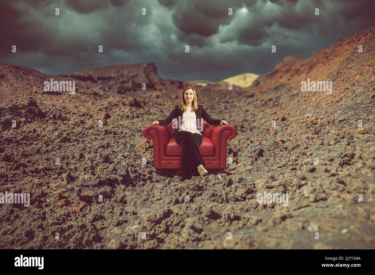 woman sitting on an armchair in a desolate place Stock Photo