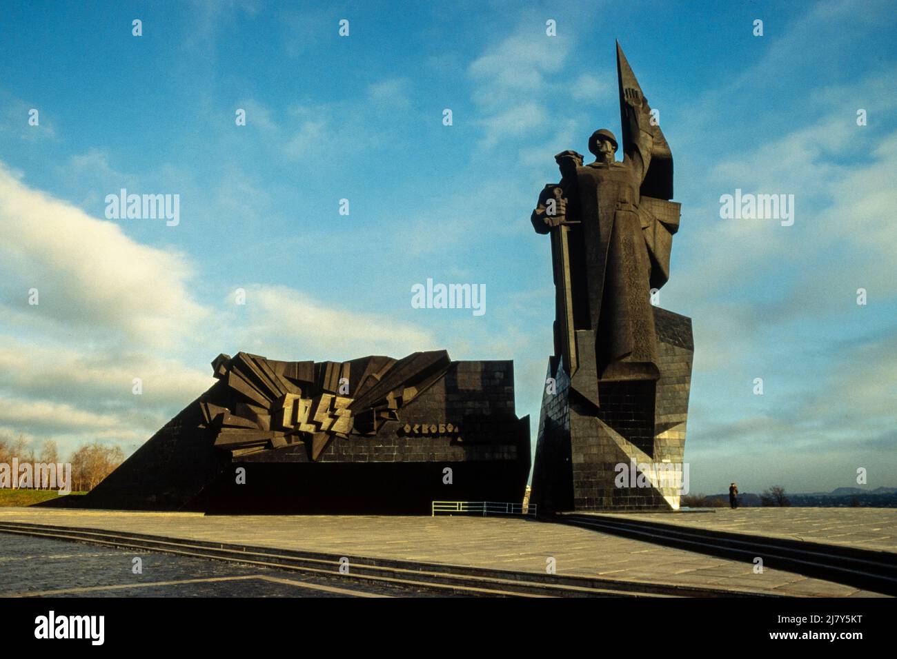 Monument to Donbas Liberators in Lenin Comsomol park, Donetsk, is of a miner and a soldier holding a downward-pointing sword and is dedicated to the memory of the military units that liberated Donbas during WW 2. Stock Photo