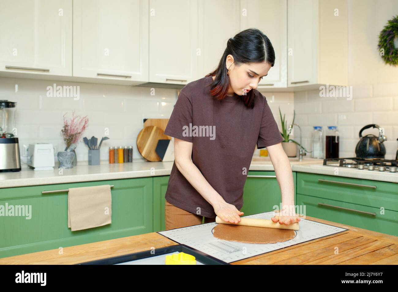 Young beautiful brunette caucasian woman 25s cooking in the kitchen Stock Photo