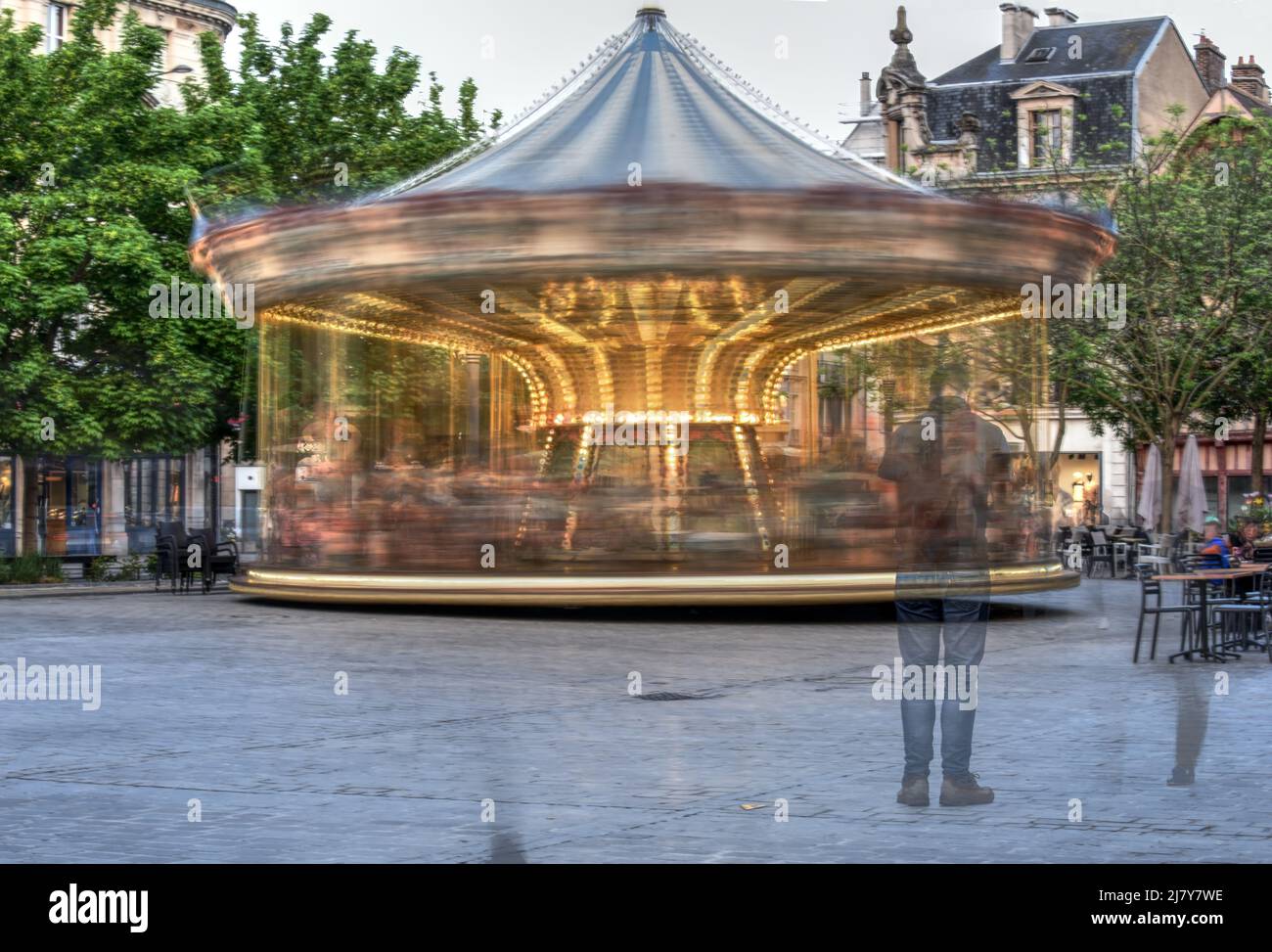 A merry-go-round spins around in this multiple exposure taken in a square in the centre of Troyes, France Stock Photo