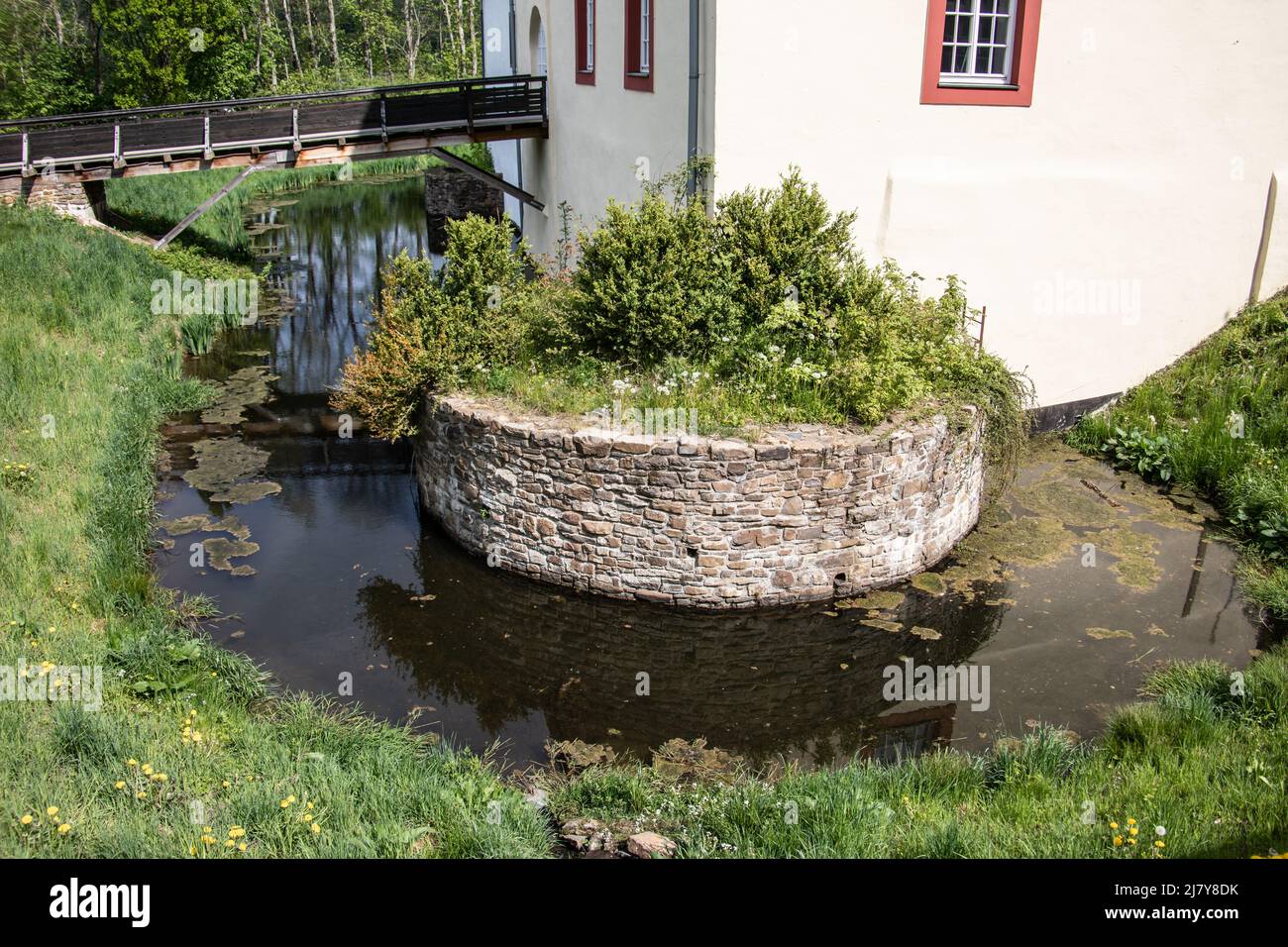 Moated castle with a moat in the countryside near Netphen Stock Photo