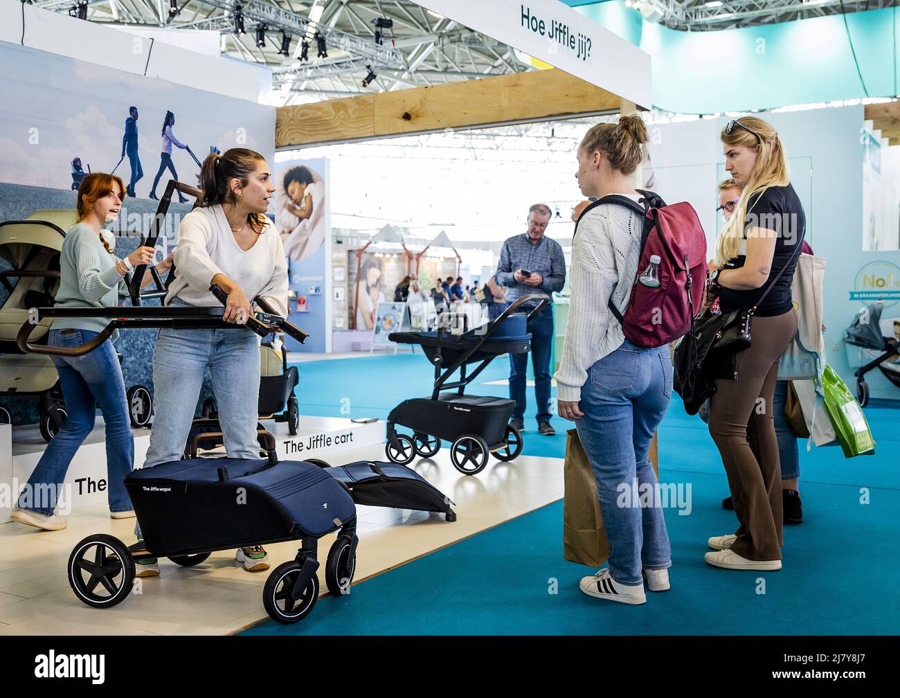 2022-05-11 15:48:17 AMSTERDAM - Visitors are given an explanation about a pram on the first day of the Nine Months Fair in the RAI. It is the first time since the outbreak of the corona pandemic that the fair on pregnancy and babies is taking place again. REMKO DE WAAL netherlands out - belgium out Stock Photo