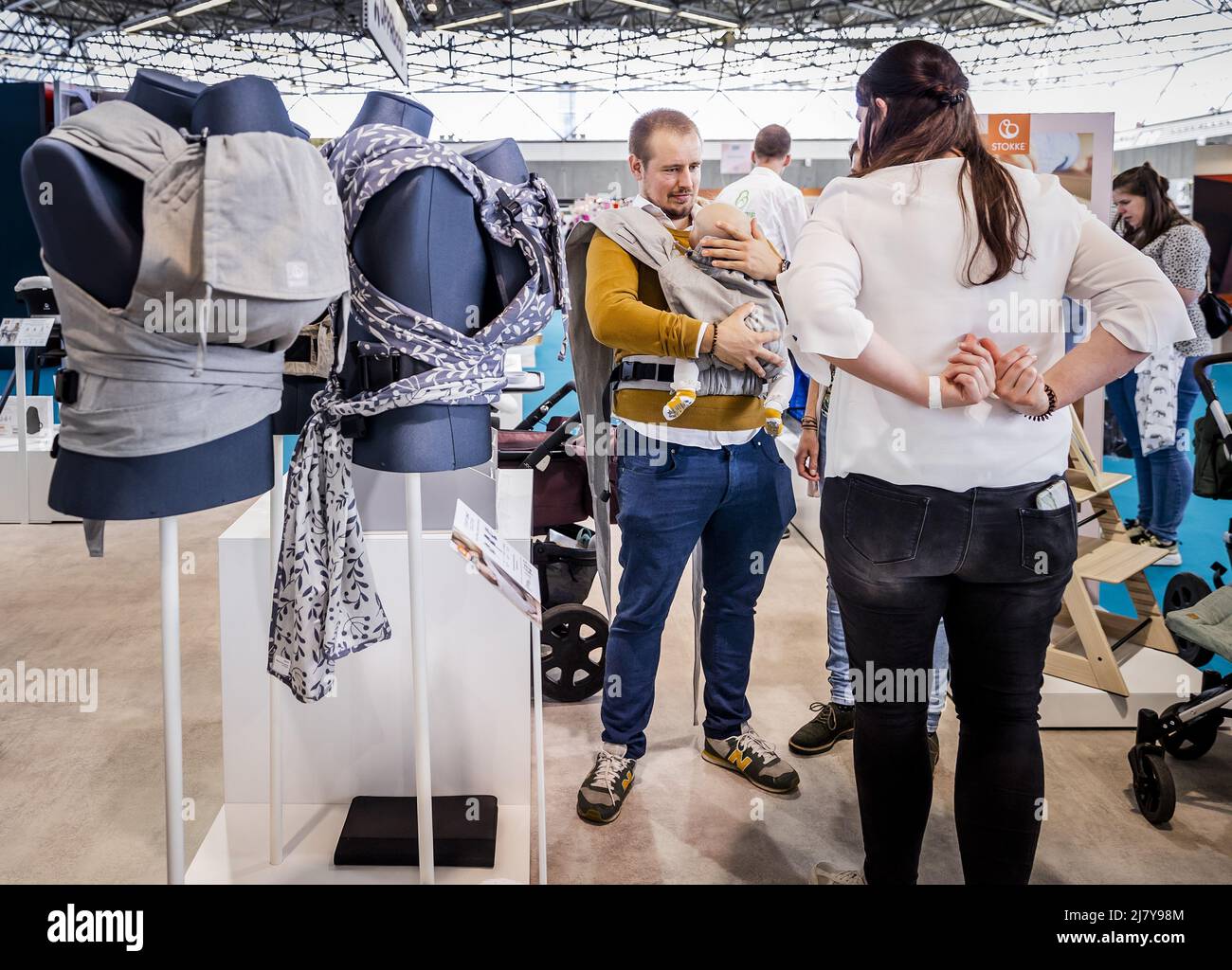 2022-05-11 15:21:40 AMSTERDAM - Visitors test baby carriers on the first day of the Nine Months Fair in the RAI. It is the first time since the outbreak of the corona pandemic that the fair on pregnancy and babies is taking place again. REMKO DE WAAL netherlands out - belgium out Stock Photo