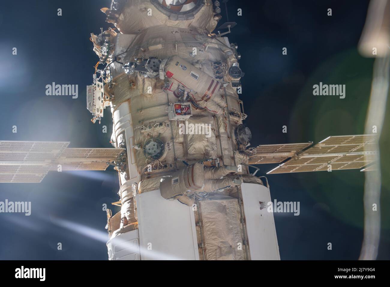 Roscosmos cosmonauts Oleg Artemyev and Denis Matveev attached to the Nauka multipurpose laboratory module during a seven-hour and 42-minute spacewalk to activate the European robotic arm on the International Space Station April 28, 2022 in Earth Orbit. Stock Photo