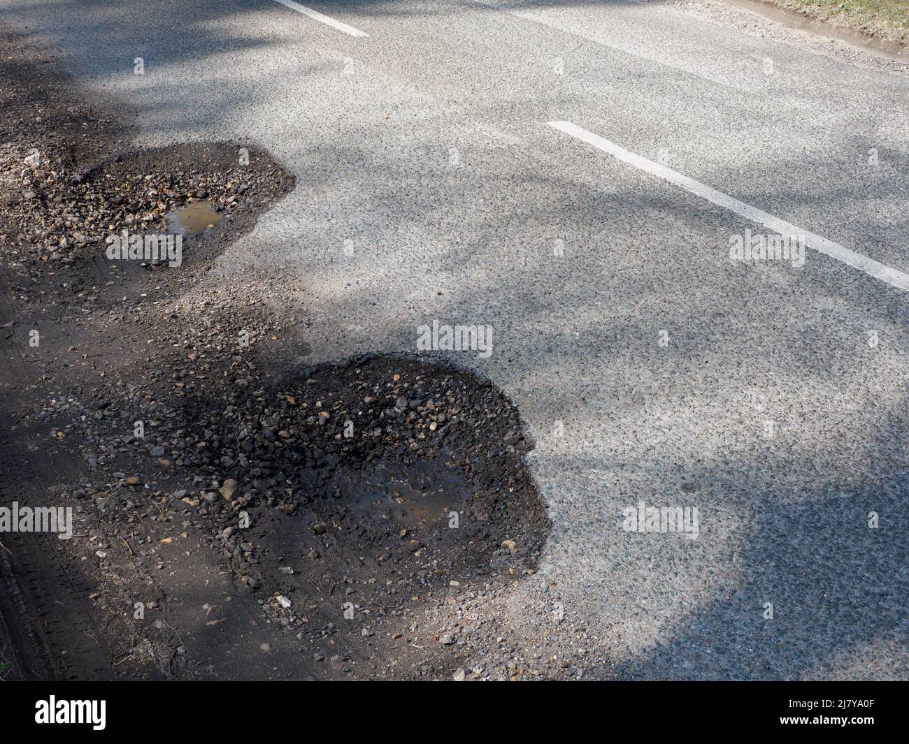 Potholes on a road, The New Forest, Hampshire, UK Stock Photo