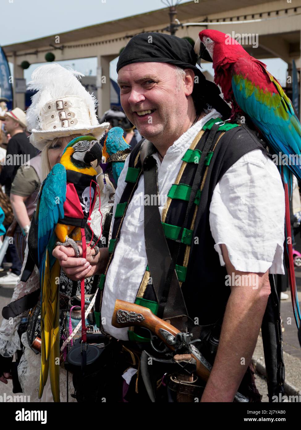 Pirate with two parrots at the Brixham Pirate Festival 2022, Devon, UK Stock Photo