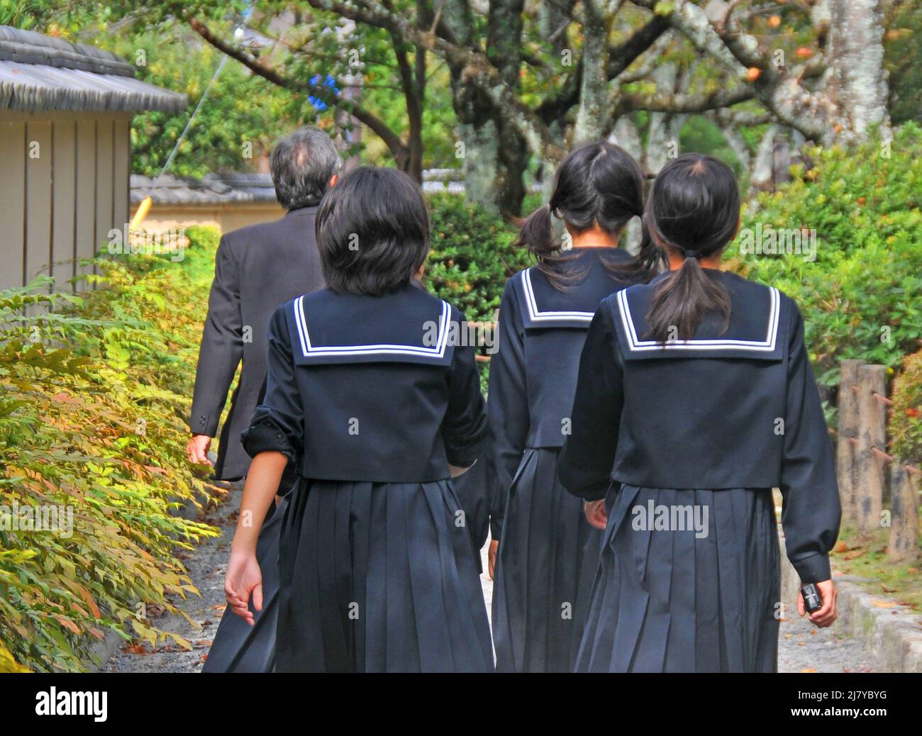 schoolgirls walking on Philosopher’s path, Kyoto, Japan Stock Photo
