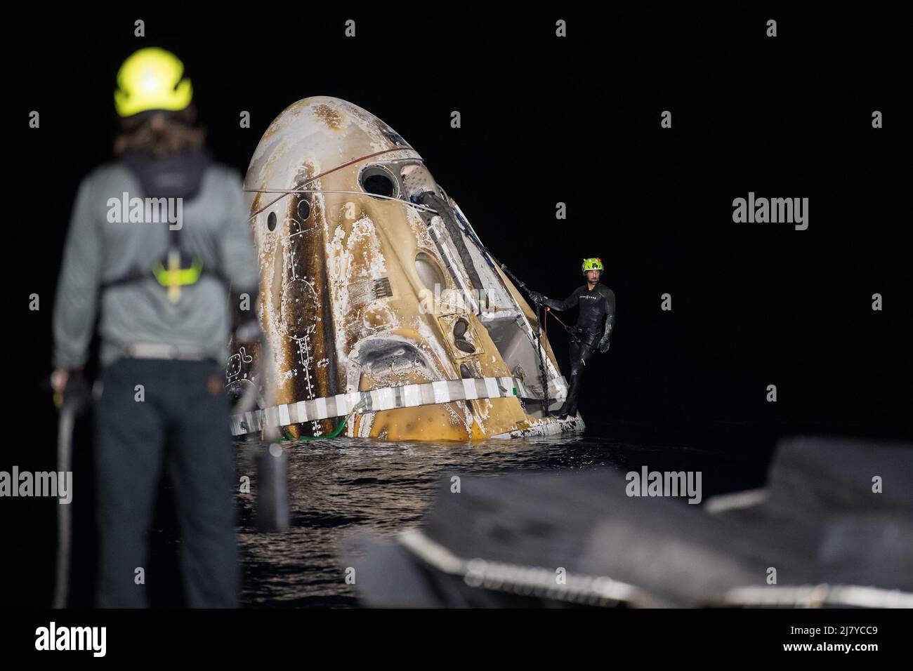 The SpaceX Crew Dragon Endurance spacecraft is secured by divers before being lifted onboard the SpaceX Shannon recovery ship after splashdown in the Gulf of Mexico May 6, 2022 off the coast of Tampa, Florida.  The capsule carried NASA SpaceX Crew-4 astronauts Raja Chari, Kayla Barron, Tom Marshburn, and ESA astronaut Matthias Maurer back to earth from 177-days aboard the International Space Station. Stock Photo