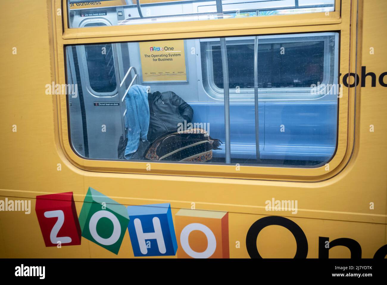 A homeless man sleeps on an E line subway train in New York on Saturday ...