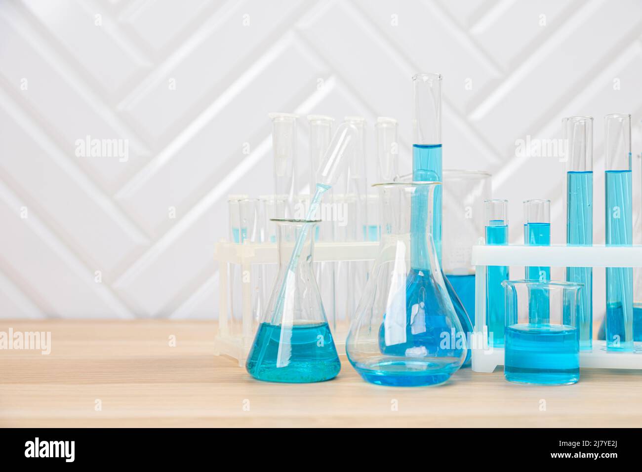 Laboratory glassware with blue liquid in a test tube. scientific ...