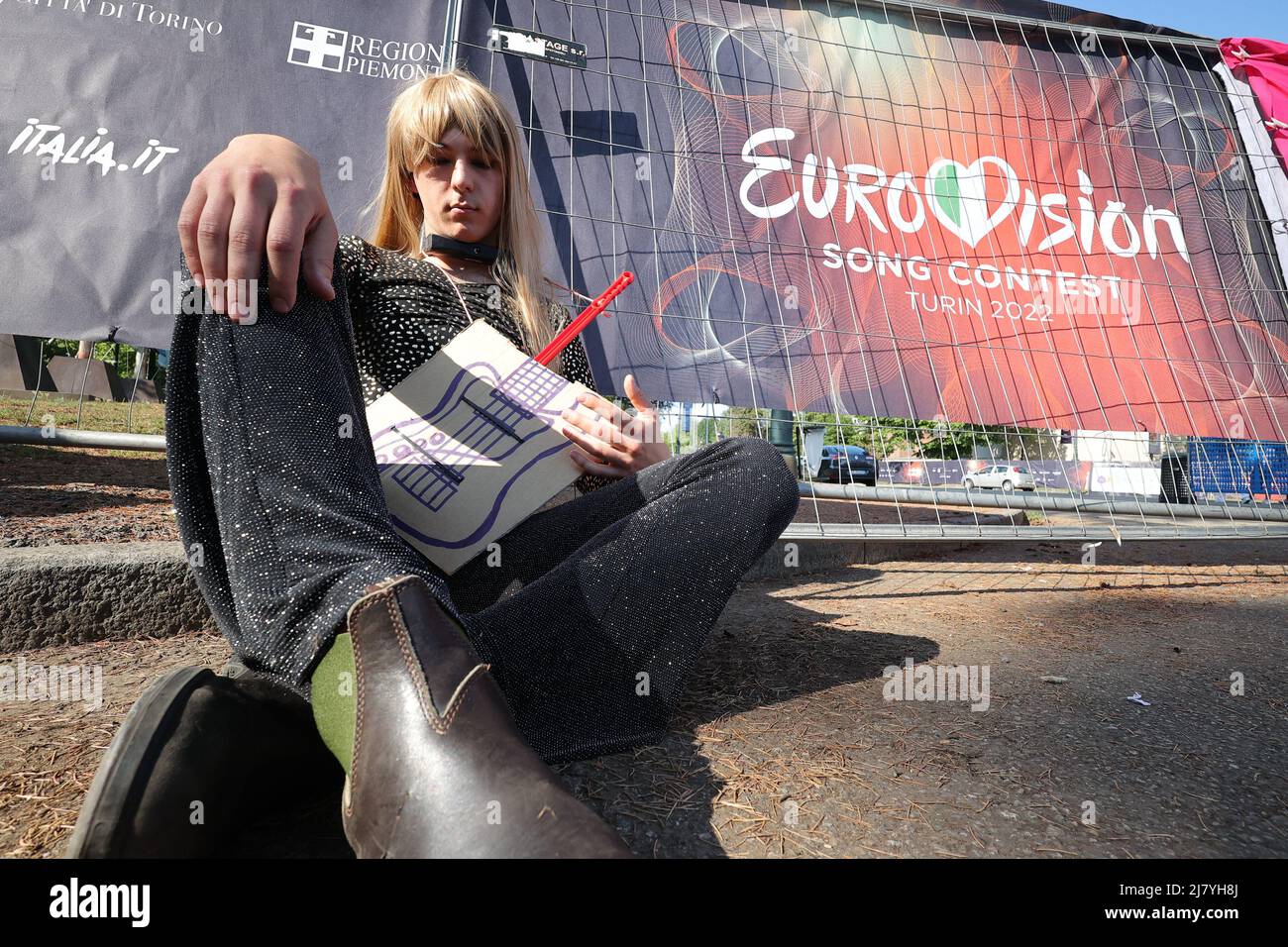 Turin, Italy. 11th May, 2022. Extinction Rebellion activists make an action disguised as Måneskin and chained to the gates of the Eurovision village. Credit: MLBARIONA/Alamy Live News Stock Photo