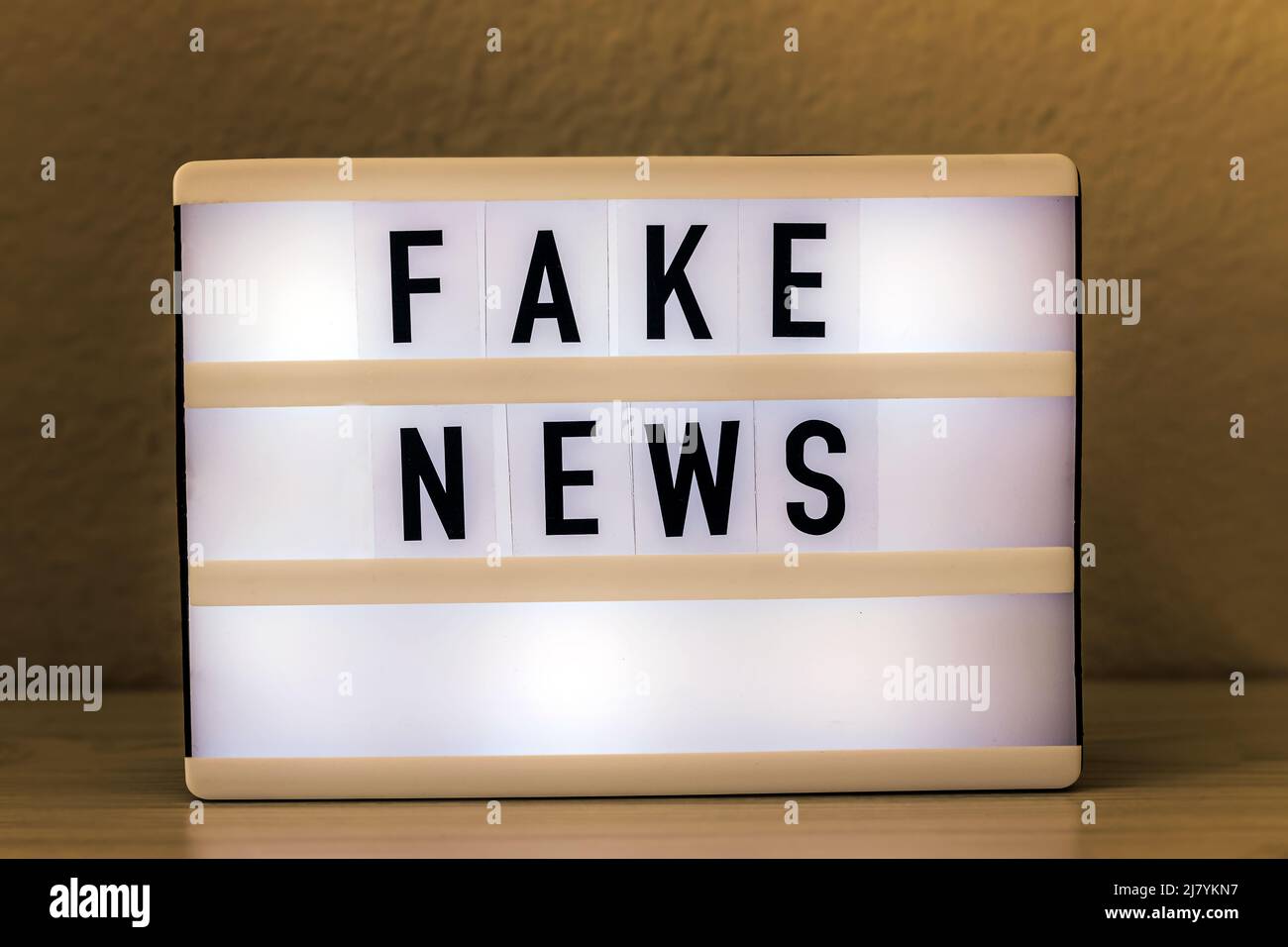 Light box with text Fake News. Journalism, propaganda, social media