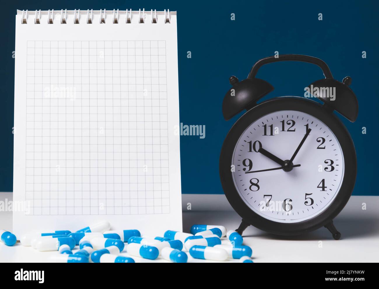 Time to take your medicine. Pill reminder. Tablets and alarm clock