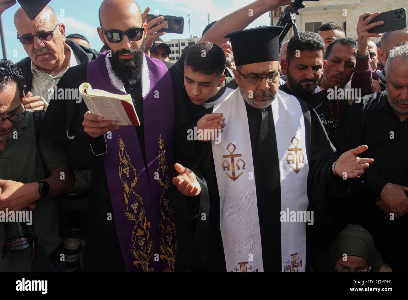 Jenin, Palestine. 11th May, 2022. Priests mourn as they pray during the ...