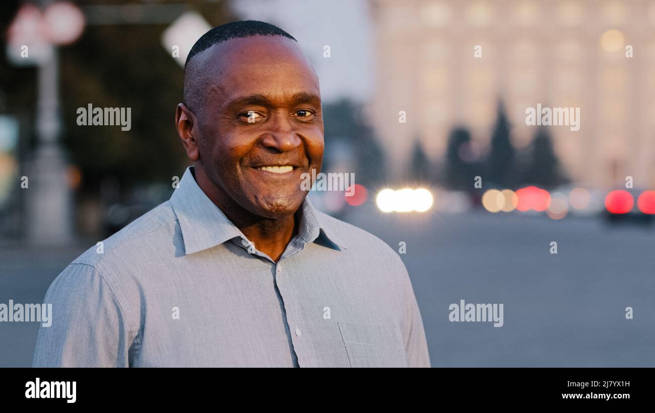 African american adult man wearing formal shirt, happy smiling male face with wrinkles, successful elegant mature businessman boss leader experienced Stock Photo