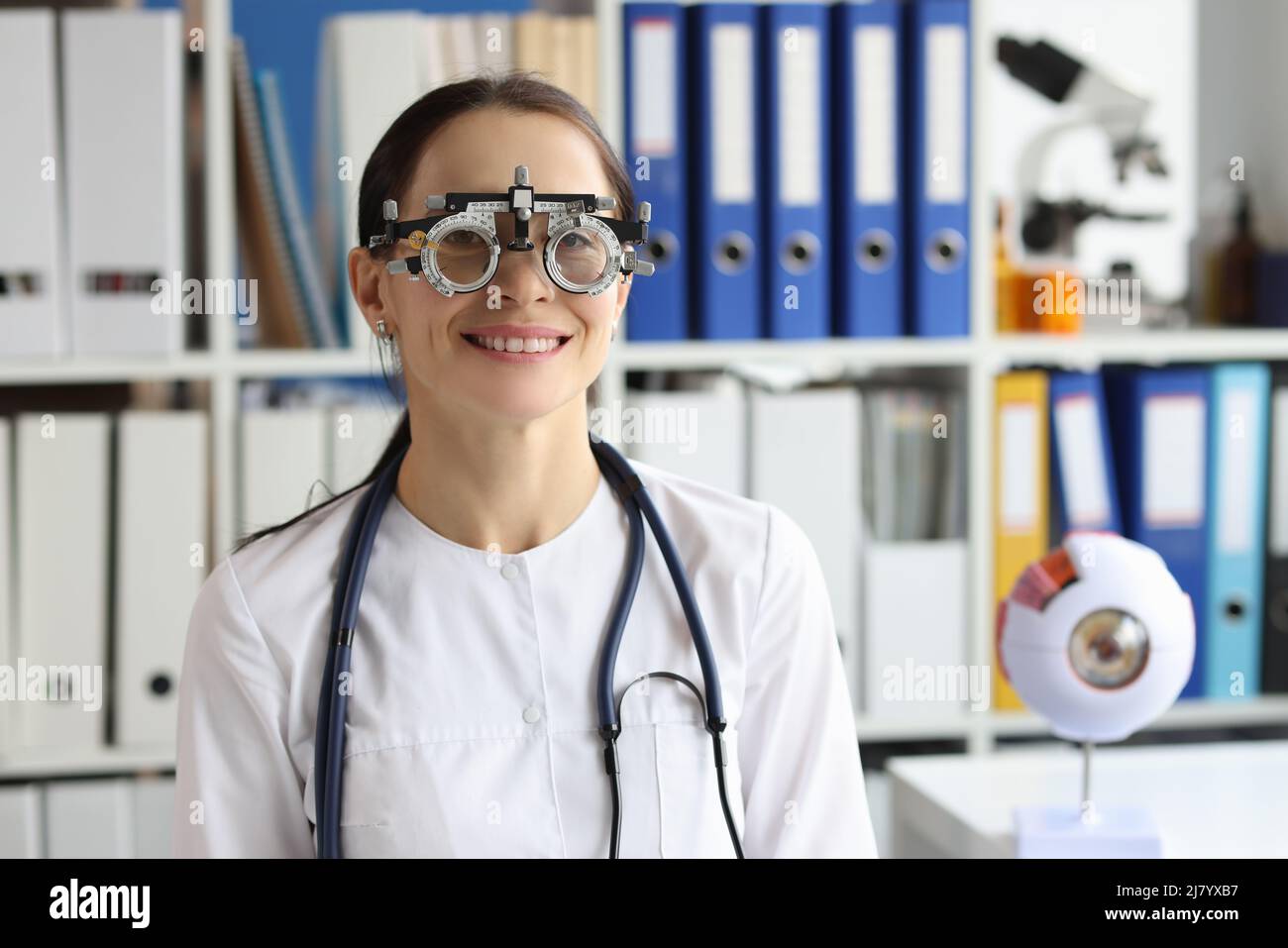 Ophthalmologist wear optometrist trial frame at ophthalmology office, select glasses for better vision Stock Photo