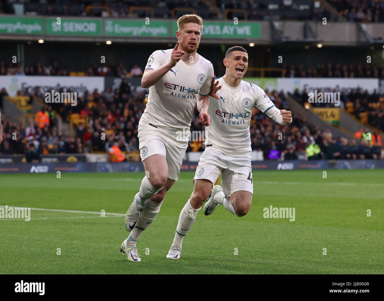 Wolverhampton, England, 11th May 2022.   Kevin De Bruyne of Manchester City celebrates scoring the first goal with Phil Foden of Manchester City during the Premier League match at Molineux, Wolverhampton. Picture credit should read: Darren Staples / Sportimage Stock Photo