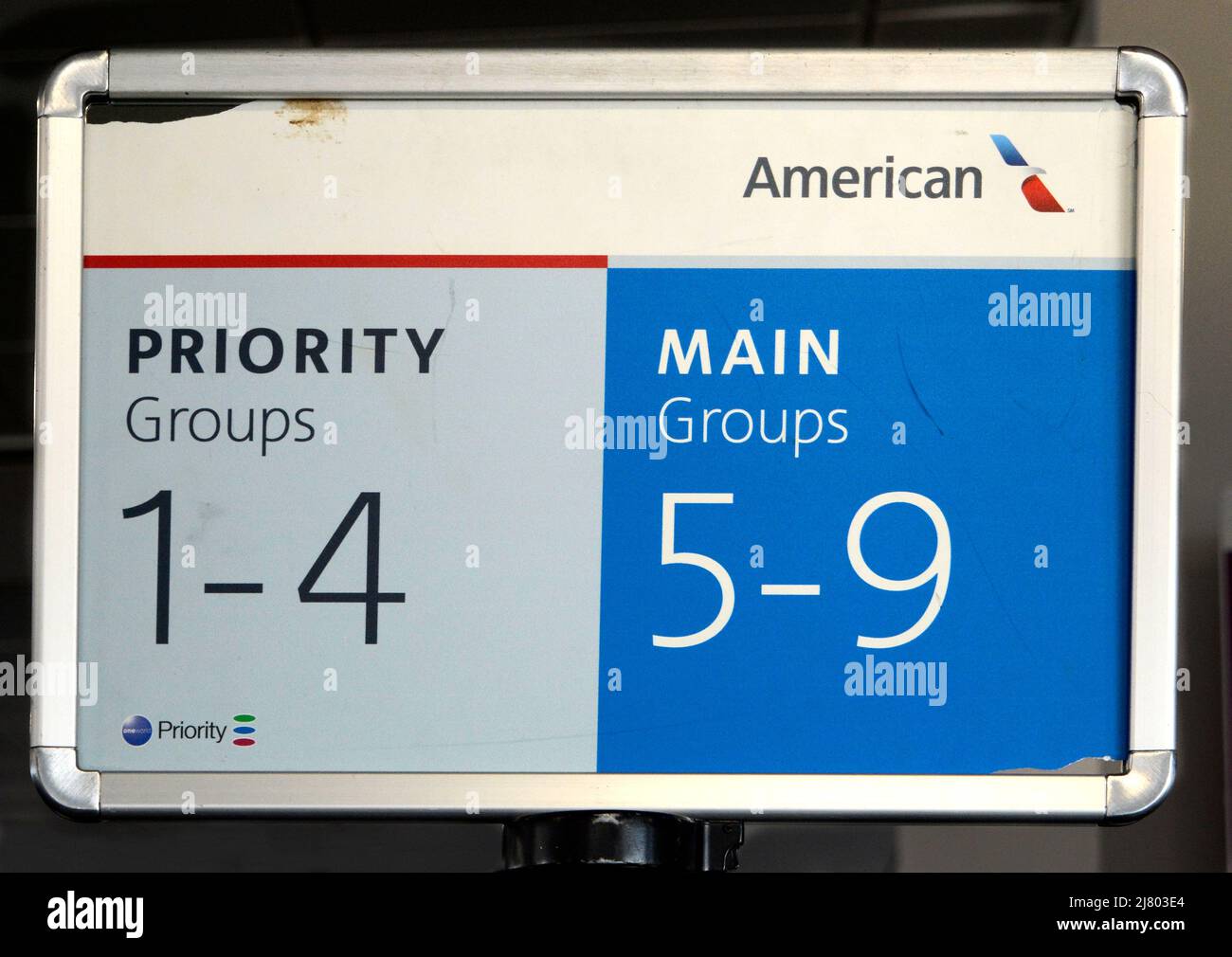 Signs indicate priority and main boarding lines for American Airlines