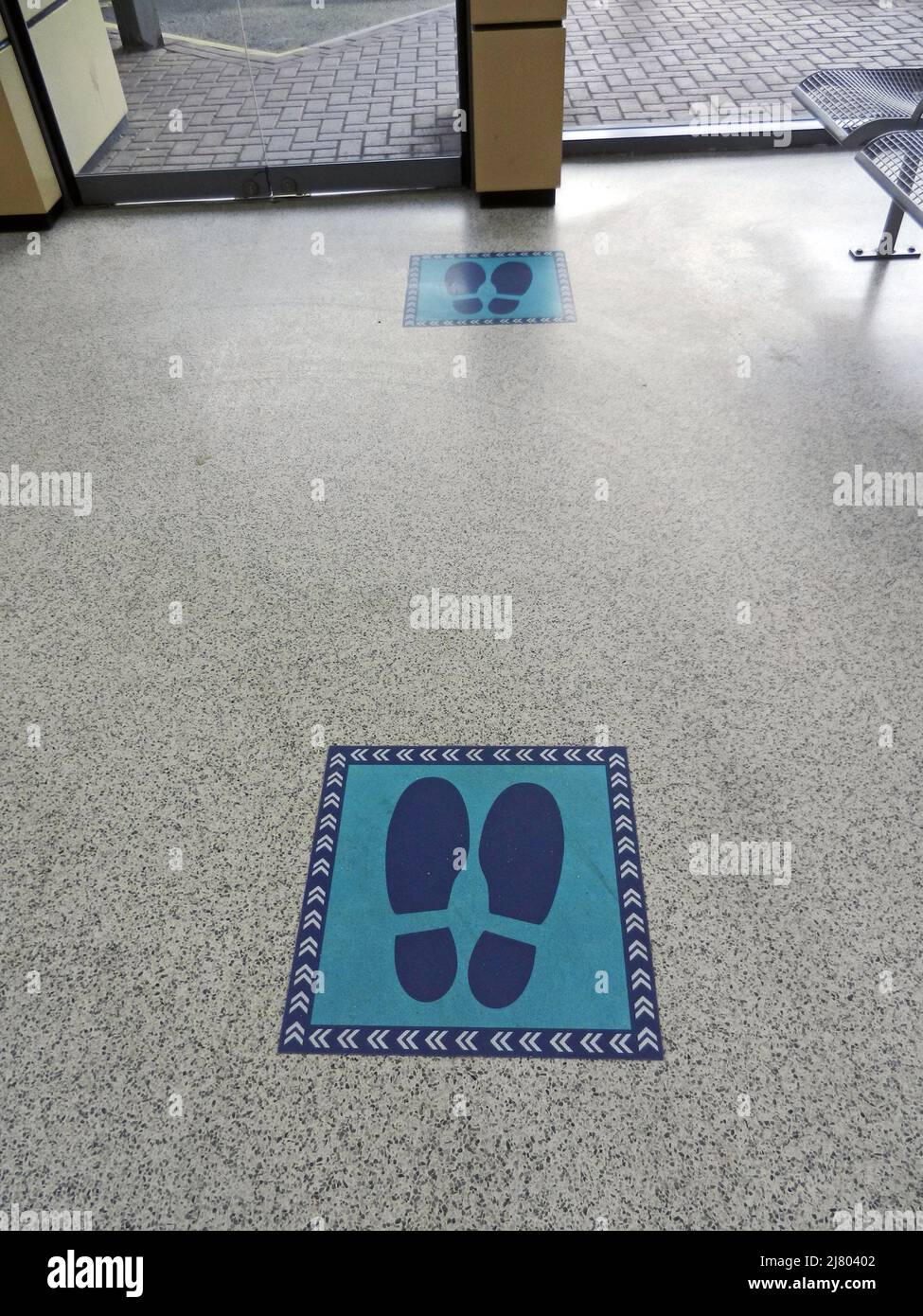 CHORLEY. LANCASHIRE. ENGLAND. 04-19-22. Social distancing markers on the floor of the bus station to aid queue control for bus boarding. Stock Photo