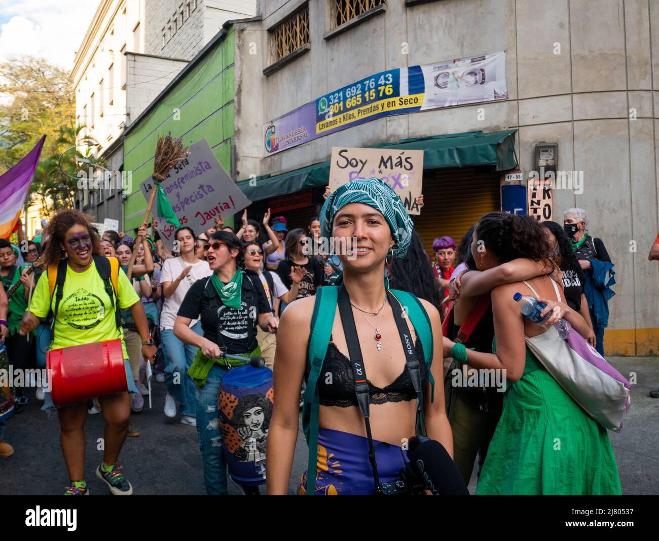 Medellin, Antioquia, Colombia - March 8 2022: Women Dressed in Purple or Green Marching and Protesting During Woman's Day with Cardboards Stock Photo