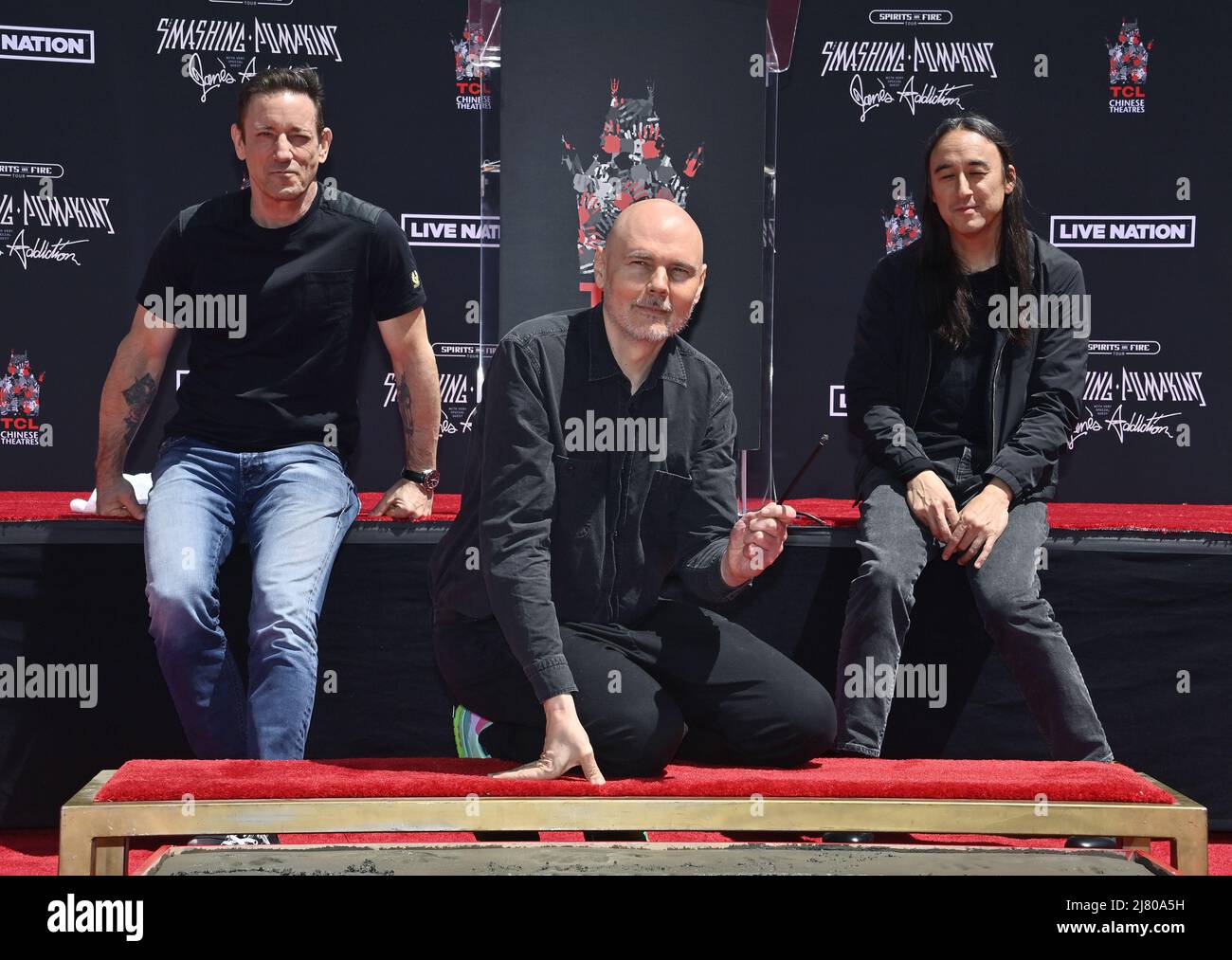 Los Angeles, United States. 11th May, 2022. Three members of the alternative rock band The Smashing Pumpkins, Jimmy Chamberlin, Billy Corgan, and Jeff Schroeder (L-R) participate in a handprint ceremony immortalizing them in the forecourt of the TCL Chinese Theatre (formerly Grauman's) in the Hollywood section of Los Angeles on Wednesday, May 11, 2022. Photo by Jim Ruymen/UPI Credit: UPI/Alamy Live News Stock Photo